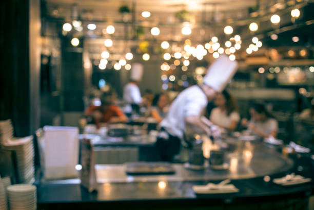 Blur chef cooking in restaurant with  customer Blur chef cooking in restaurant with  customer sitting food and drink establishment stock pictures, royalty-free photos & images