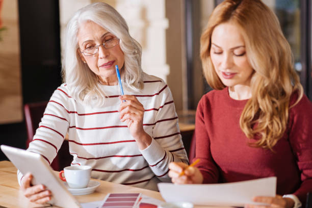 istock Thoughtful senior woman looking at the tablet while thinking 888009628