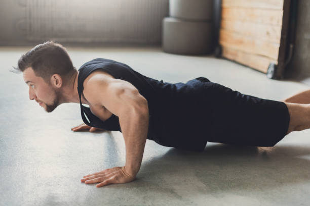 istock Young man fitness workout, push ups or plank 888010034