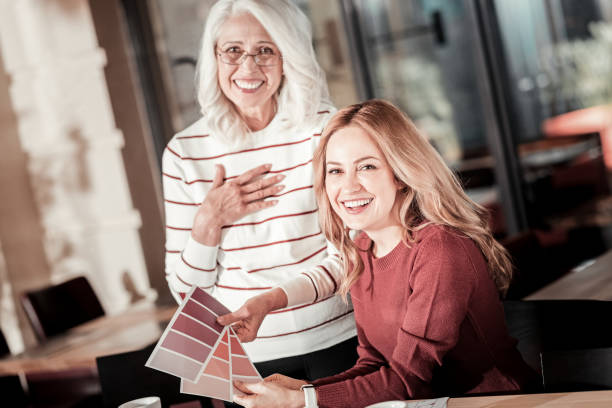 istock Friendly cheerful designers laughing while choosing a color 888010136
