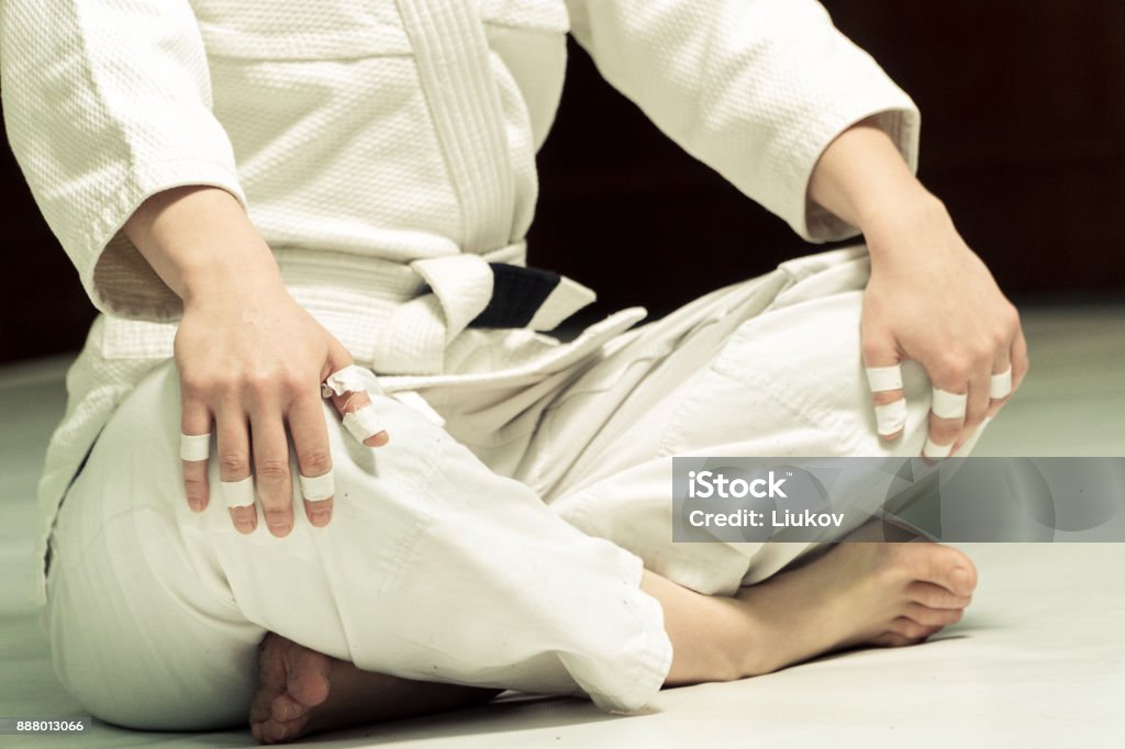 A girl in a kimono kneads before training in judo and jujitsu Active Lifestyle Stock Photo