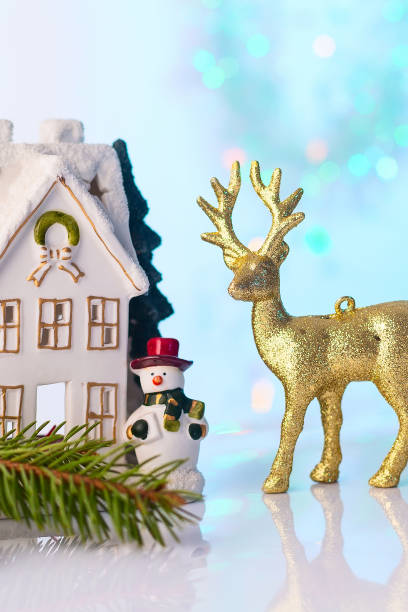 istock Christmas house and reindeer with bokeh lights 888016338