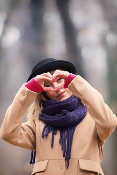 istock Cute smiley girl holding a heart - shape. 888016426