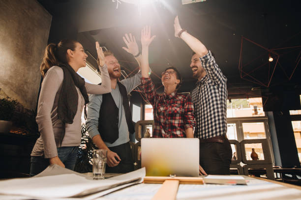 istock Below view of cheerful freelance workers celebrating their success. 888018926
