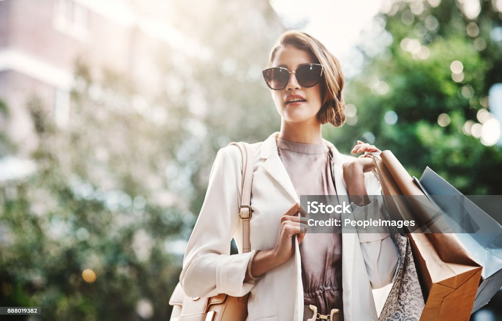 Shopping always makes her happy Shot of a gorgeous and elegant young woman out on a shopping spree Luxury Stock Photo