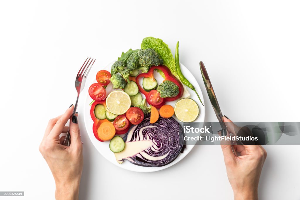 woman going to eat salad Cropped image of woman going to eat salad isolated on white Eating Stock Photo