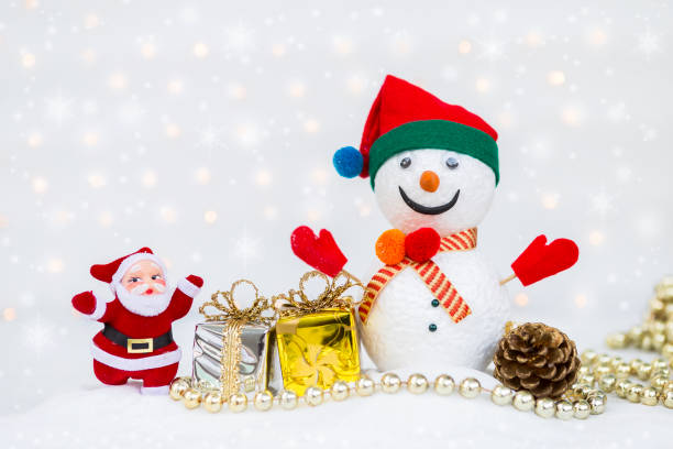 istock Santa Clause and snow man with silver and gold gift box over blurred bokeh on white background 888045126