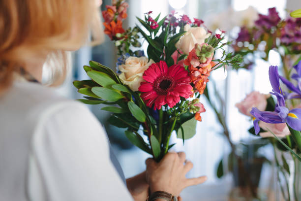 istock Mixed flowers in hands on female florist 888045620