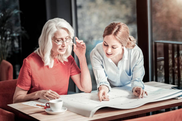 istock Creative enthusiastic colleagues checking all the lines on their scheme 888049566