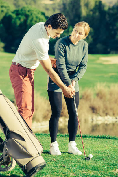 istock Golf couch is training girl to play golf 888063580
