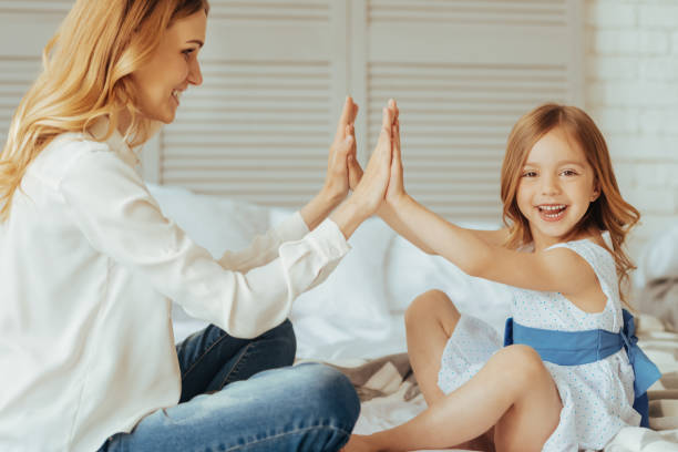 istock Positive cute girl sitting opposite her mom 888064264