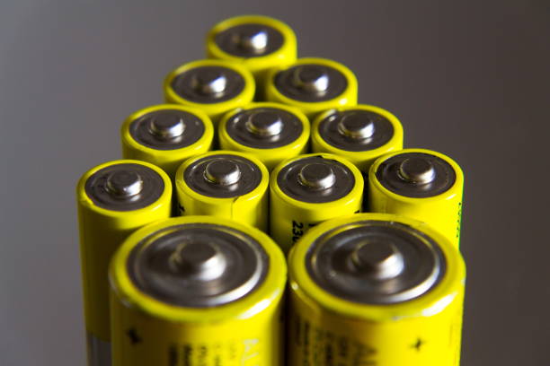 istock Stack of yellow AA batteries close up, electricity storage concept 888067202