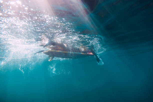 istock Surfer woman on surfboard, surfing in tropics 888067334
