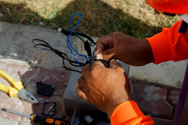 istock Electrician wiring cable for garden lighting. 888067388