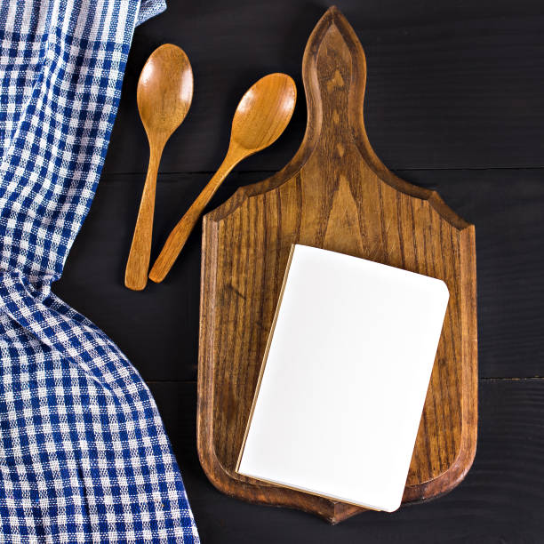 istock A blue kitchen towel and a notebook on a dark wooden background. Menu, place for text, recipe. 888071936