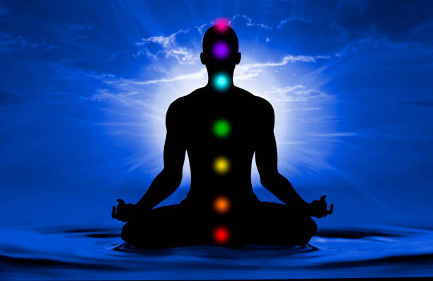 Silhouette of human doing yoga and where has scored seven chakra points Silhouette of human doing yoga and where has scored seven chakra points chakra stock pictures, royalty-free photos & images