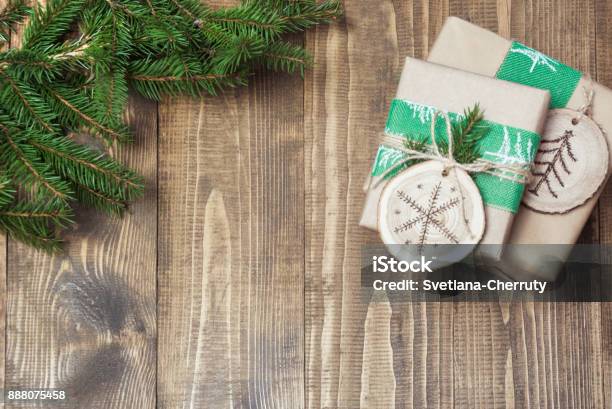 Christmas Gift Box In Rustic Style Wrapped In Paper With Decor Of Wooden  Sliced With Woodburning Symbol Stock Photo - Download Image Now - iStock