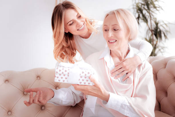 istock Delighted elderly woman holding a present 888094598
