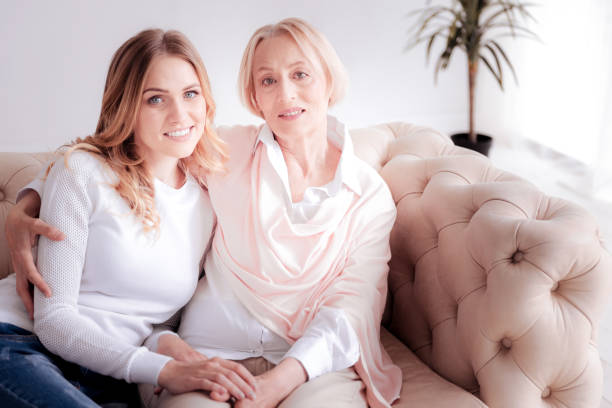 istock Delighted positive mother and daughter resting on the sofa 888094668