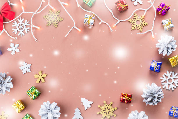 istock Colorful Christmas background with conifer cones, snowflakes, presents and Christmas lights on a warm background 888094708