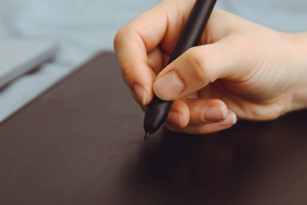 istock Graphic Tablet Being Used with a Pen by Female Hand 888095396