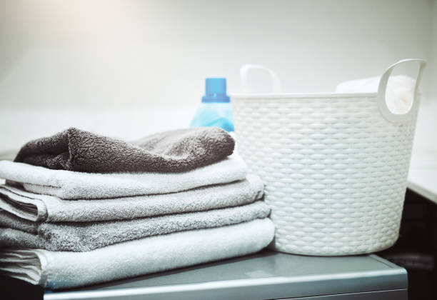 Keeping laundry clean and fresh Still life shot of linen and a laundry basket on a washing machine fabric softener photos stock pictures, royalty-free photos & images