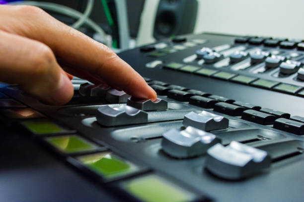 istock hand on a light, mixing desk fader in blur television gallery 888100156