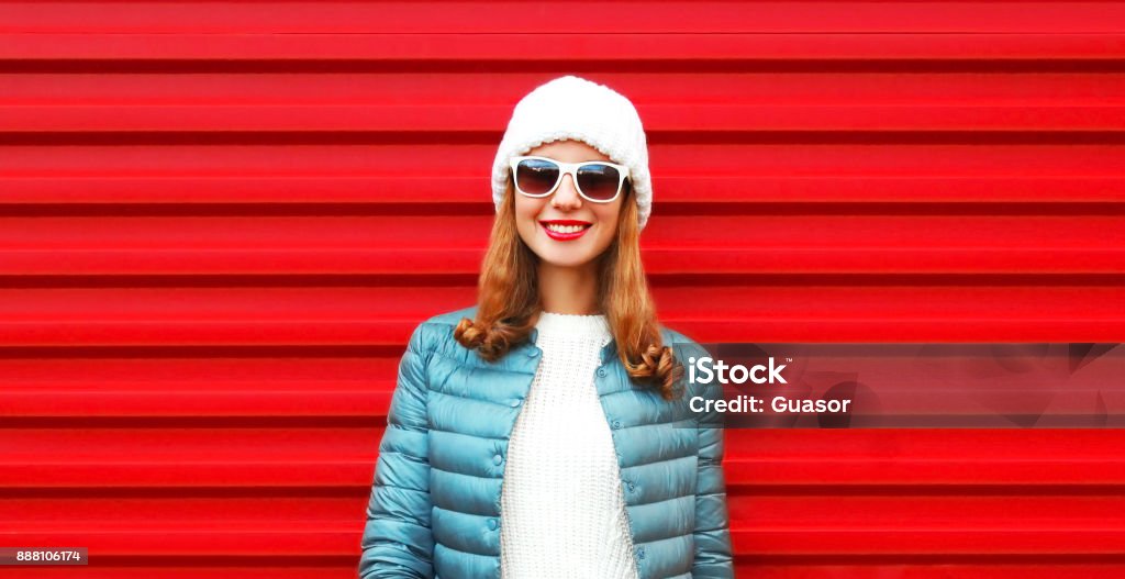 Fashion portrait pretty smiling woman on a red background close-up Adult Stock Photo
