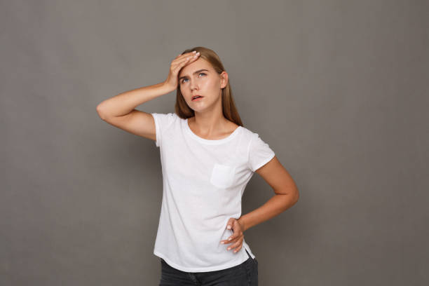istock Concentrated woman thinking on gray background 888106576