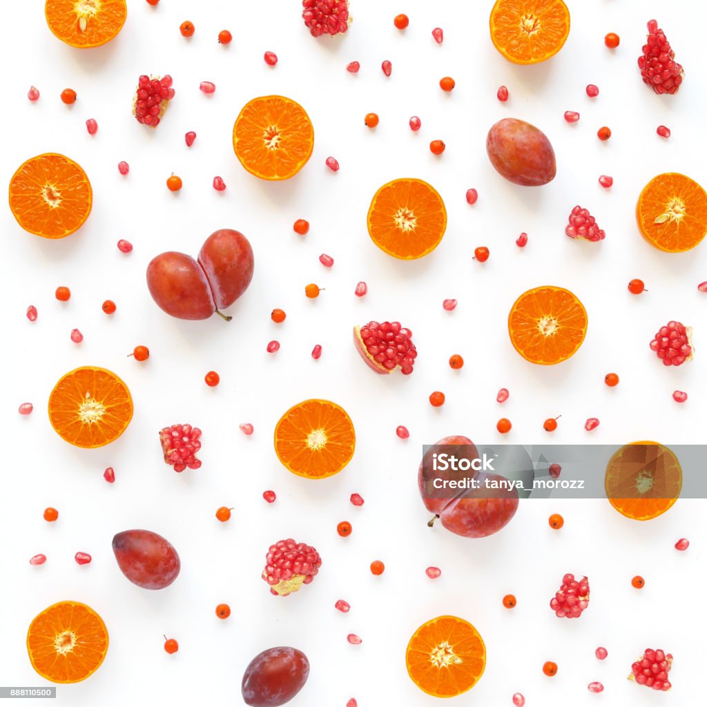 Pattern of fresh fruits. Food background. Top view, flat design. Pattern of fresh fruits. Food background. Top view, flat design. Collage of plum in the form of heart, slices of mandarins, grains of pomegranate. Alertness Stock Photo