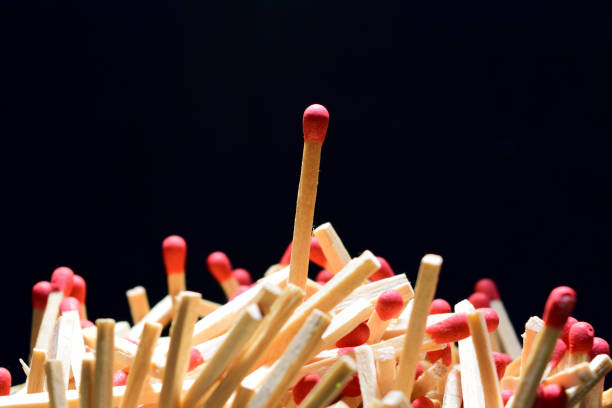 istock Vertically stacked matche and pile of matches 888116902