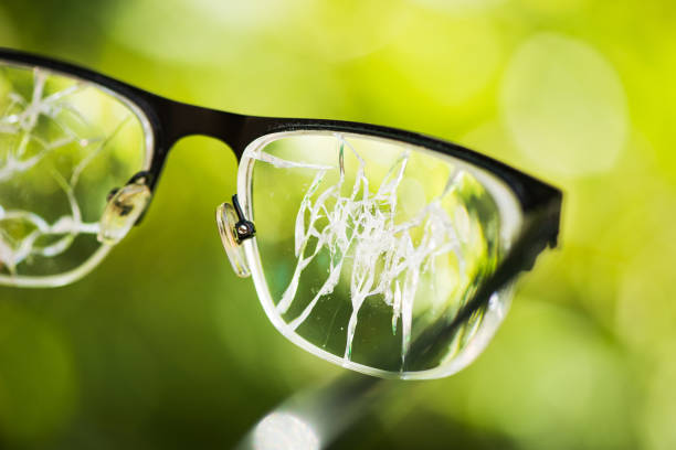 istock broken glasses on the green background 888120028