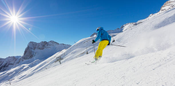 istock Skier on piste running downhill 888121544