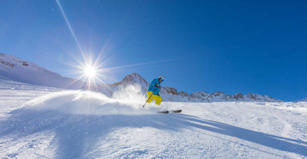 istock Skier on piste running downhill 888123480