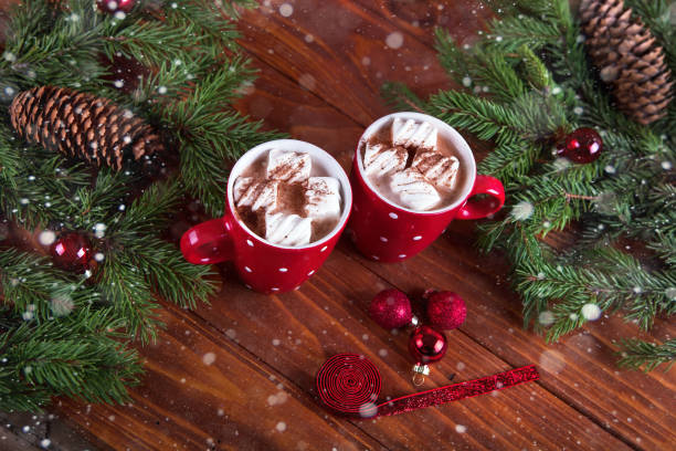 istock Christmas hot chocolate with marshmelow on a dark wooden background, christmas tree branches decorating. 888123886