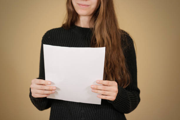 istock Girl reading blank white A4 flyer brochure booklet. Leaflet presentation. Pamphlet hold hands. Woman show clear offset paper. Sheet template. 888127144