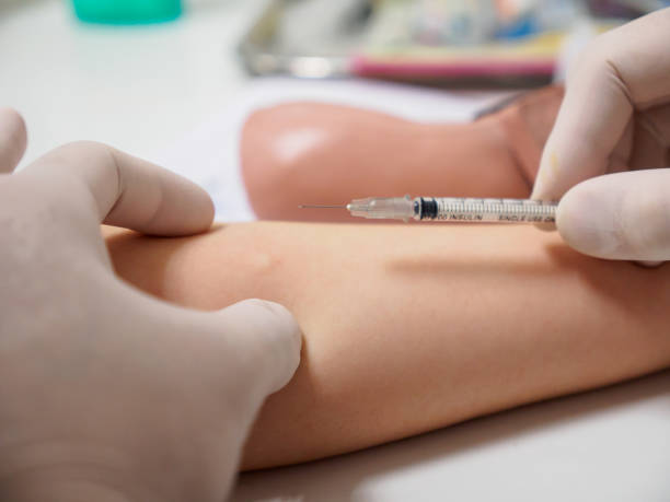 Physician injects insulin stock photo