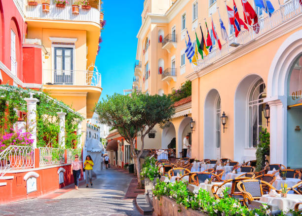 Tourists at Street cafes on Capri Island Capri, Italy - October 3, 2017: Tourists at Street cafes on Capri Island, Italy table ledge stock pictures, royalty-free photos & images