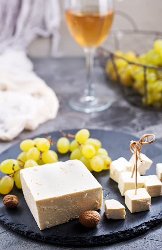wine,grape and cheese on a table