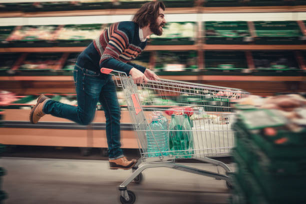 istock Happy man having fun in the supermarket 888137244