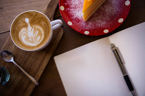 Top view coffee latte aroma cup and tasty christmas cake relaxtime waiting for idea on paper note on wood table in cafe coffee shoop