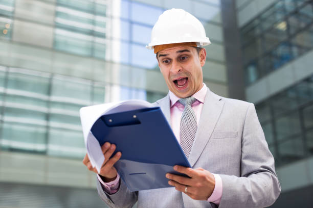 istock Dissatisfied businessman holding papers 888140502