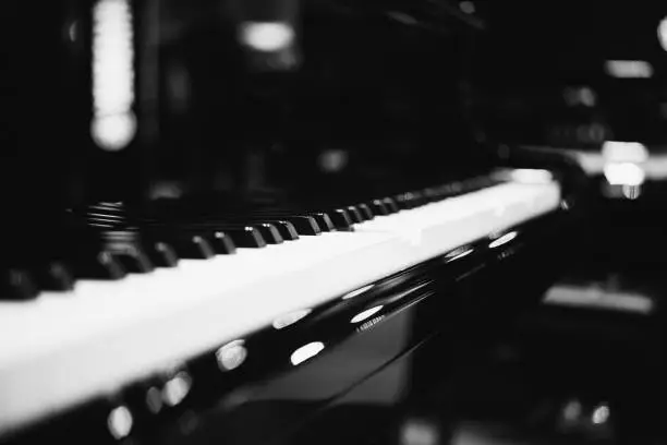 Piano keys on black classical grand piano play a classic song