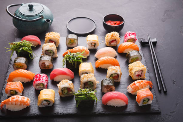 istock Sushi and rolls background, japanese cuisine 888146194