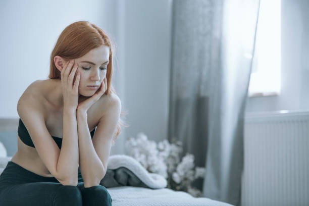 Worried girl with eating disorders Worried skinny girl sitting on bed and waiting for help. Eating disorders concept self destructive stock pictures, royalty-free photos & images