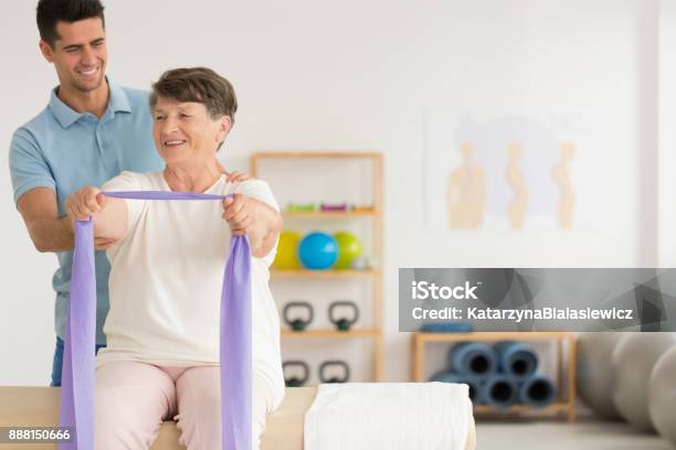 Smiling Physiotherapist Helping Older Woman Stock Photo - Download Image Now - Physical Therapy, Senior Adult, Senior Women