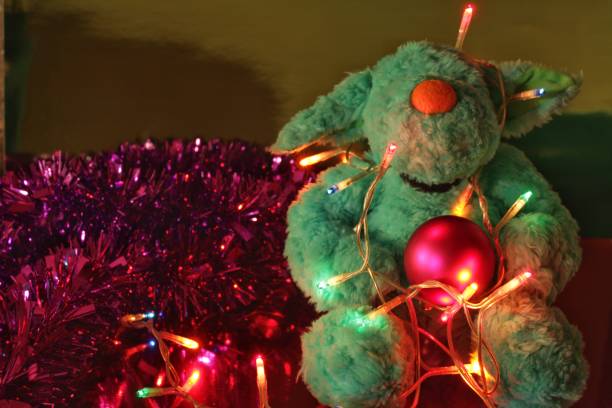 istock Funny Teddy bear and Christmas lights 888150702