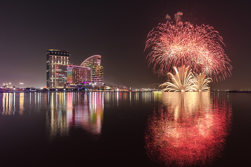 Celebration of UAE National Day with fireworks over the Festival City district. Dubai, United Arab Emirates.