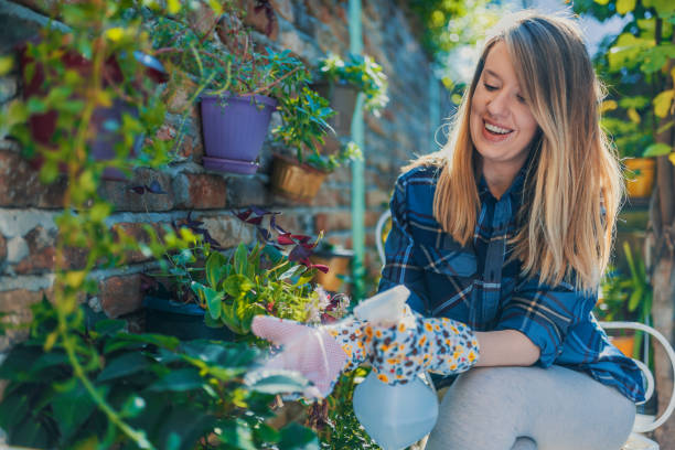 istock Young woman gardening 888151002