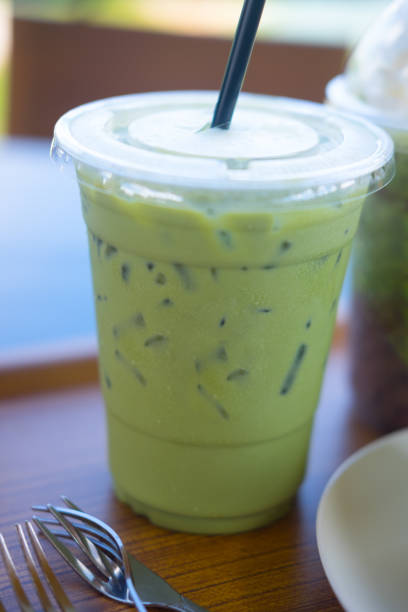 istock Iced green tea with green drinking straw in a plastic glass 888151218
